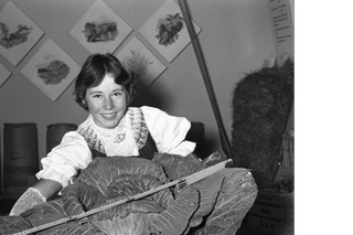 A young woman with a record sized cabbage