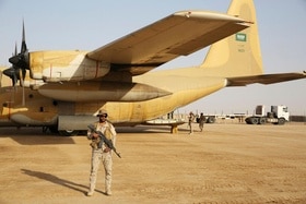 militare saudita di guardia davanti a un aereo da trasporto