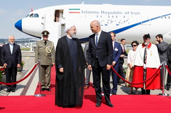 Rouhani e Berset su un tappeto rosso davanti a un aereo.