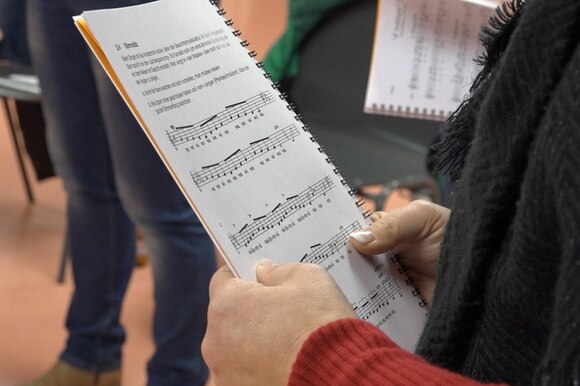 Woman holding music sheet