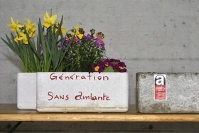 Un vaso di fiori in cemento con la scritta Génération sans amiante e uno simile in eternit, vuoto