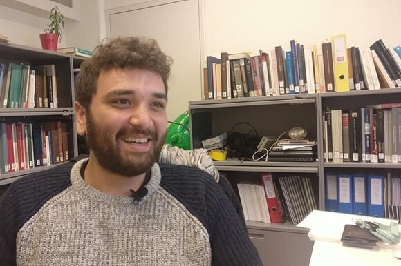 Domenico Brunacci sorride seduto in ufficio