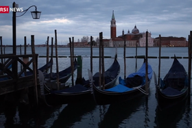 Gondole ferme, attraccate su un canale di Venezia che si intuisce essere il canale della Giudecca
