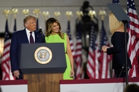 Donald e Melania Trump si avvicinano al puplito presidenziale mentre sorridono a Ivanka, di lato e di schiena