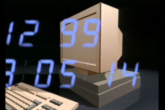 Immagine di un computer anni 90 stilizzato con, sovraimpresse, ora e data 12.99