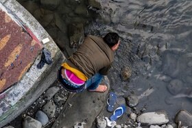 A man washing himself in the river