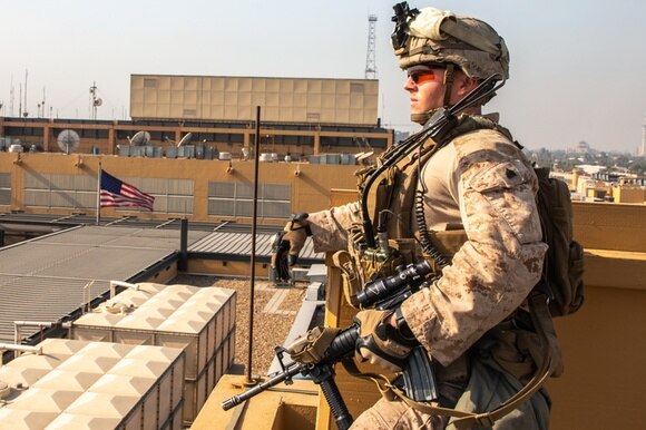 soldato sorveglia dal tetto di un edificio