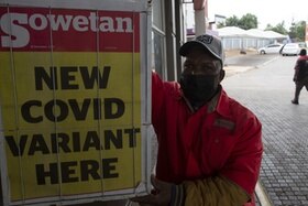 Un uomo vicino al lancio del giornale Sowetan con scritto New Covid Variant here