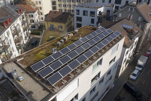 tetto di palazzo ricoperto quasi interamente di pannelli solari