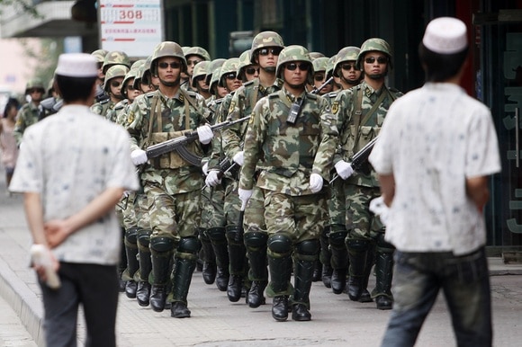 A Chinese military police unit patrols the streets of Urumqi, capital of Xinjiang province.