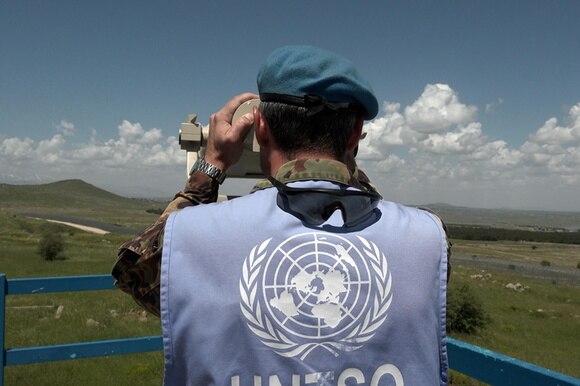 A Swiss military observer keeps watch over the Golan Heights in Israel